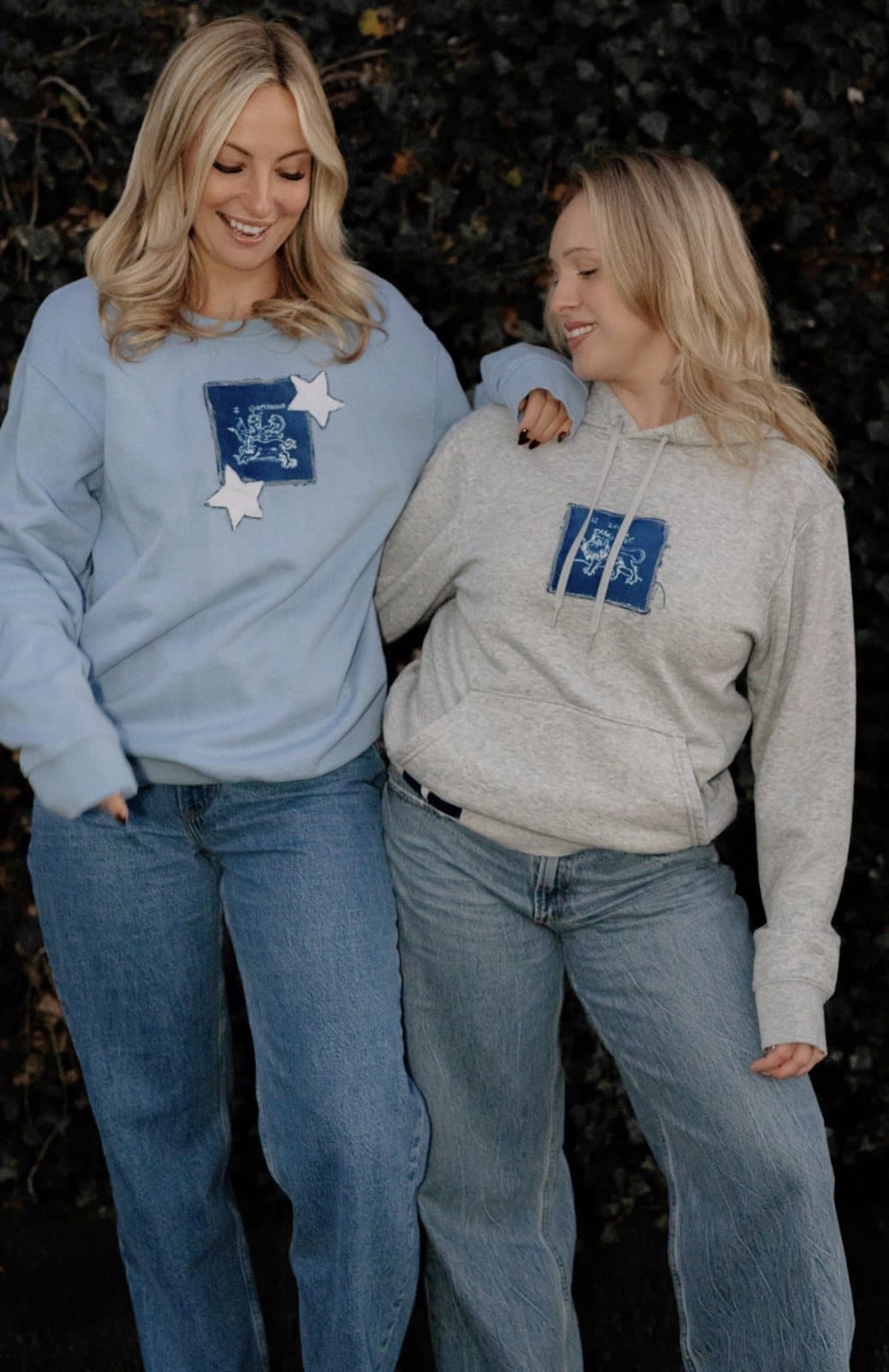 Two friends in a reworked crewneck and hoodie with matching denim patches